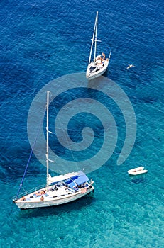 Sailing boats and swimmers at Punta Negra on Elba island, Italy photo