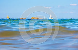 Sailing boats and waves seen by a swimmer at sea level, photography taken in Vendée