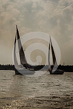 Sailing boats with white sails sailing in the deep blue sea.Sailing regatta. Yachting.