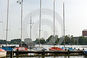 Sailing boats at a wooden pier on a lake