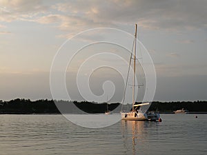 Sailing boats and yachts are floating on a peaceful surface of theAdriatic Sea,Croatia,Europe. In the background the coast with Me photo