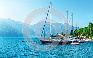 Sailing boats yachts on lake with mountains