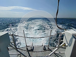 Sailing in calm blue seas with powerful propeller wash