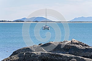 Sailing Catamaran At Anchor Offshore From Beach