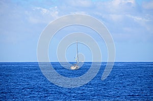Sailing catamaran with open sails. Sailing catamaran in the middle of the sea in a tropical landscape