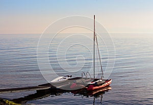 Sailing catamaran at the pier at sea