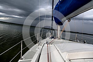 Sailing concept with boat and lake water storm weather