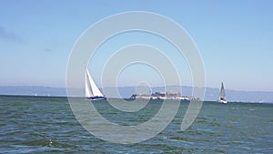 Sailing down the San Francisco bay on a small yacht in California near a Golden Gate bridge