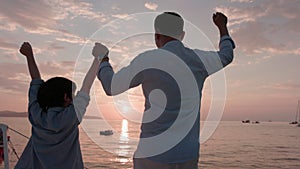 Sailing with his father. On the yacht, a father and son exchange hello. The sun was setting at the time. Family ties in Asia