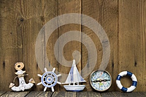 Sailing holiday: Greeting card with nautical items on wooden board.