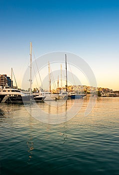 Sailing and luxury motor yachts in marina of Zeas. Sunset and v