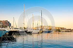 Sailing and luxury motor yachts in marina of Zeas. Sunset and v