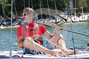 Sailing man on boat in lake