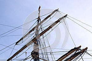 Sailing masts on the blue sky, detail of a historic ancient ship