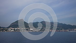 Sailing on the Mediterranean sea near Amalfi coast in Campania, province of saltern, Italy. Looking at hillside town