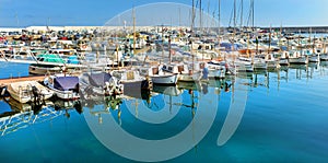 Sailing, motor boats moored seawall. Blanes, Spain