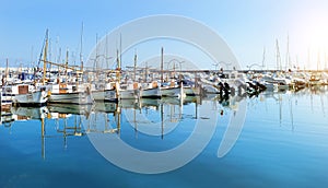 Sailing, motor boats moored seawall. Blanes, Spain