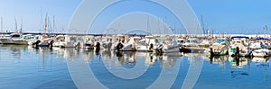 Sailing, motor boats moored seawall. Blanes, Spain