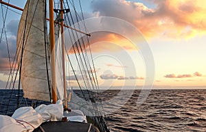 Sailing old schooner at sunset, travel and adventure concept