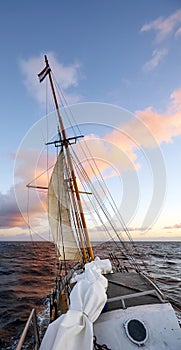 Sailing old schooner at sunset, travel and adventure concept