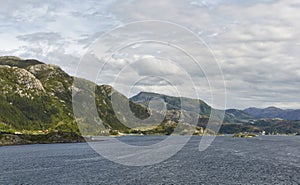 Sailing in the open waters of Geirangerfjord near Maloy and looking over to the Island of Vagsoy. photo