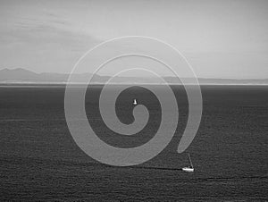 Black and white image of two sailboats in the open sea