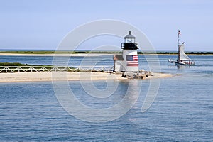 Sailing Past Lighthouse on Nantucket Island on a Summer Day