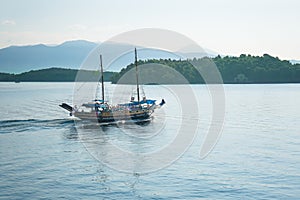 Sailing pirates boat on the sea at sunset