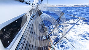 Sailing. Racing yacht in the Mediterranean sea on blue sky background.