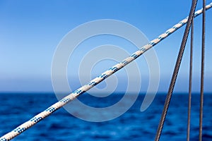 Sailing Ropes in Front of bight blue Ocean and Sky Background