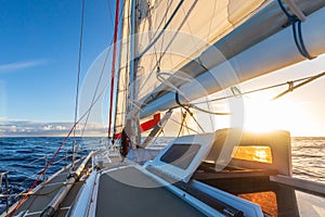 Sailing on sailboat yacht with beautiful sunset light clear blue sky and flat sea in drake passage, summer cruising, closeup of