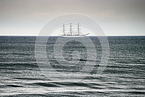 Sailing ship on the Baltic sea. Three-masted full-rigged frigate ship Dar Mlodziezy on the high seas.