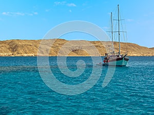 A sailing ship basks in the crystal clear waters around Tiran island in the Red Sea near Sharm El Sheik, Egypt