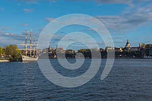 Sailing ship is in foreground of Skeppsholmen islands at evening