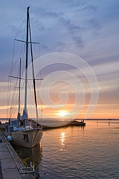 Sailing ship in the harbor of lake Vaettern at sunset. Lighthouse in the background