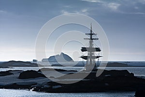 Sailing ship among the icebergs