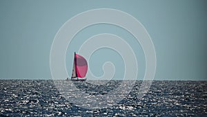 Sailing ship luxury yacht with red sails in the sea in the evening sunlight. Sailboat luxury summer adventure, active