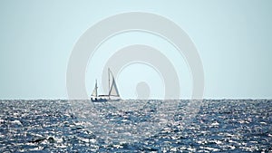 Sailing ship luxury yacht with white sails in the sea in the evening sunlight. Sailboat luxury summer adventure, active