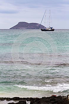 A sailing ship moored by North Seymour Island, with a smaller island in the background, Galapagos Islands, Ecuador