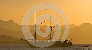 Sailing ship on the sea at sunrise sunset. Indonesia. Islands.