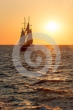 Sailing ship silhouette in sunset on the sea