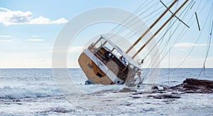 sailing ship stranded in the shoal after a storm on a Calasetta beach