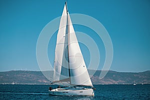 Sailing ship yacht with white sails in the Aegean Sea.