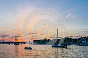 Sailing ships on the river Warnow in the sunset during the Hanse Sail in Rostock, Germany