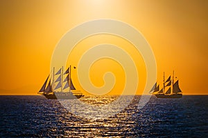 Sailing ships on the sea in sunset photo