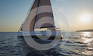 Sailing at the sunset. Modern sailing yacht.