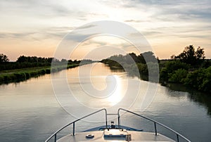 Sailing at sunset on a waterway in the Camargue