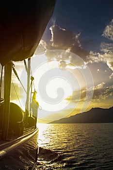 Sailing to sunset with sailing boat