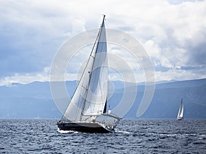 Sailing in the wind through the waves at the Aegean Sea in Greece. Luxury.