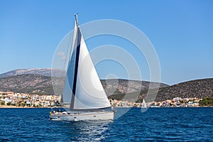 Sailing in the wind through the waves at Aegean Sea in Greece.